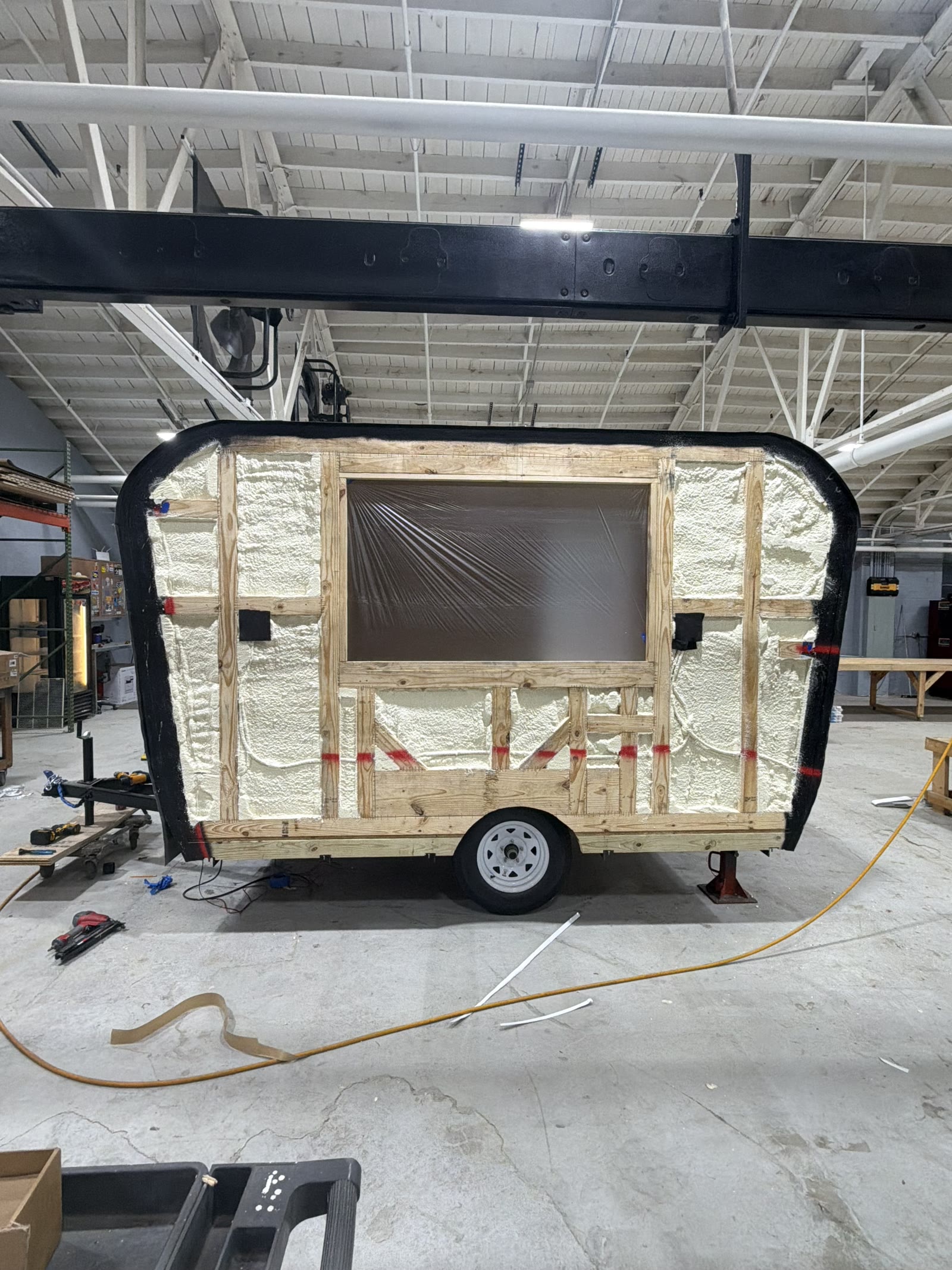 Trailer framing with closed-cell foam insulation and service window opening